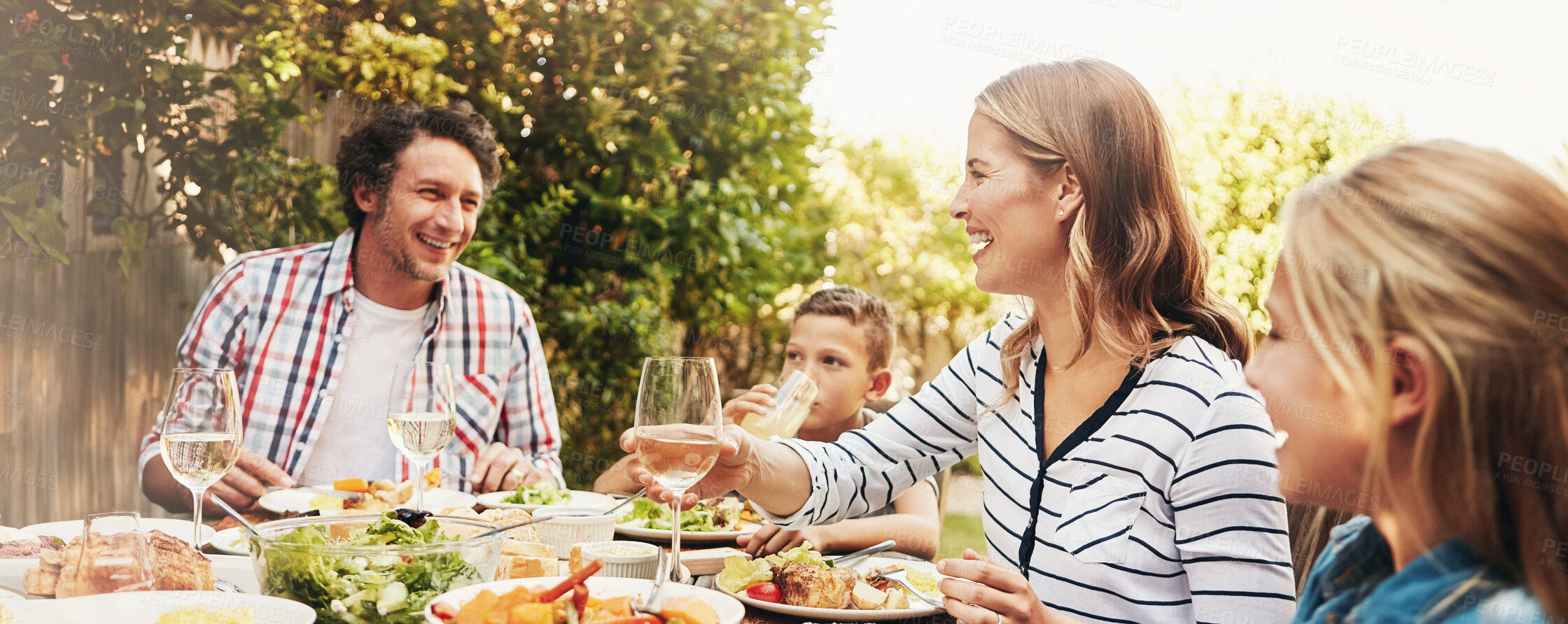 Buy stock photo Dad, mom and happy kids at outdoor lunch with smile, thanksgiving and family eating together in backyard. Father, mother and children at table for garden picnic with food, bonding and love on banner