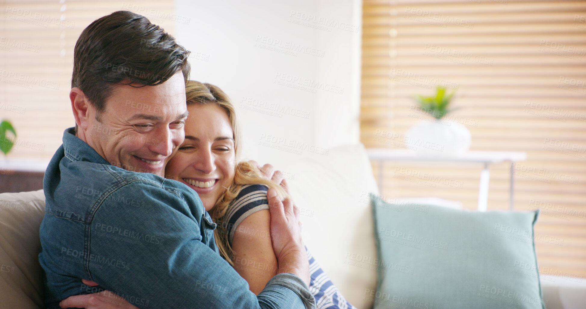 Buy stock photo Love, smile and couple hug in home for care, support or romantic connection to partner in marriage. Relax, happy man and woman embrace in living room for loyalty, trust or commitment for relationship