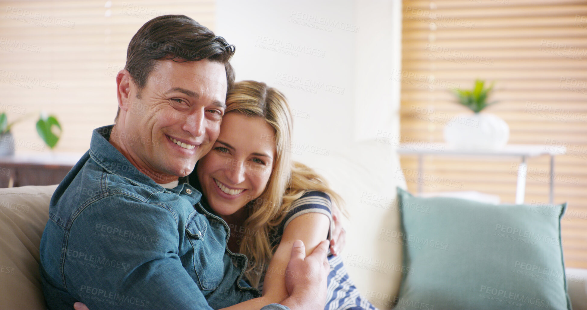 Buy stock photo Portrait, smile and couple hug in home for love, support or romantic connection to partner in marriage. Face, happy man and woman embrace in living room for loyalty, trust and commitment in Germany