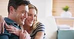 Love, happy and couple hug in home for care, support or romantic connection to relax with partner on sofa. Smile, man and woman embrace for loyalty in marriage, trust and thinking of relationship