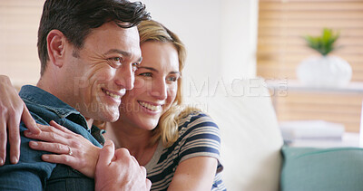 Buy stock photo Love, happy and couple hug in home for care, support or romantic connection to relax with partner on sofa. Smile, man and woman embrace for loyalty in marriage, trust and thinking of relationship