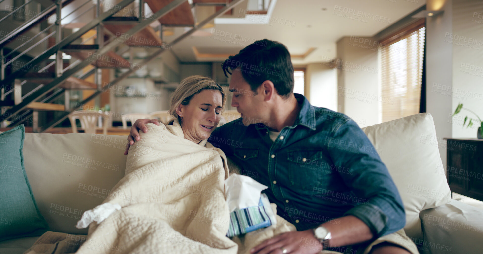 Buy stock photo Woman, crying and man on sofa for support, comfort and emotional security in home. Couple, depression or sad wife in living room with empathy, grief or loss with hug for care, stress or mental health