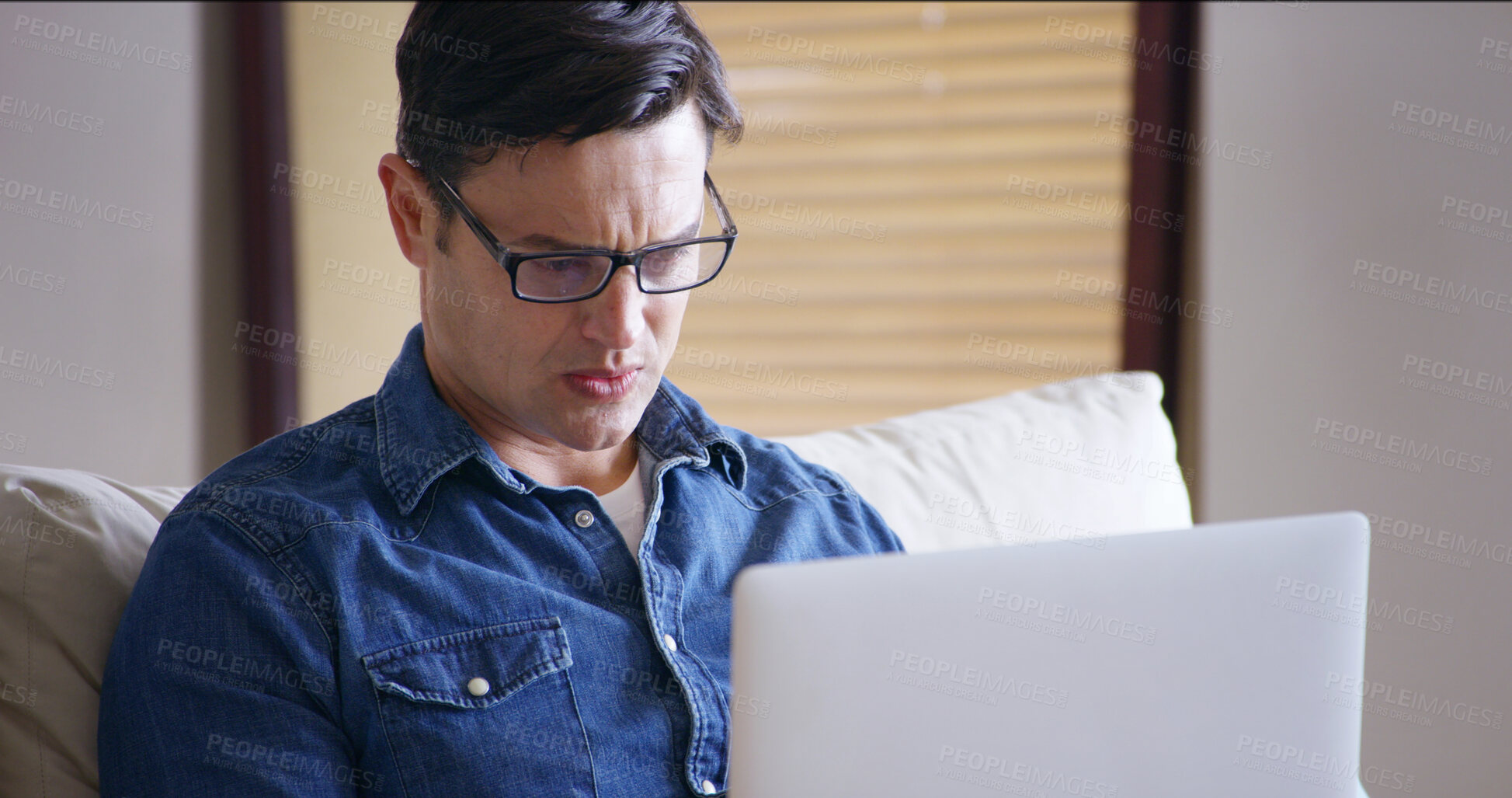 Buy stock photo Man, stress and bills on laptop in home with couch, payment and financial debt. Mortgage, anxiety and invoice check on tech with investment, tax and bankruptcy with inflation and cost planning