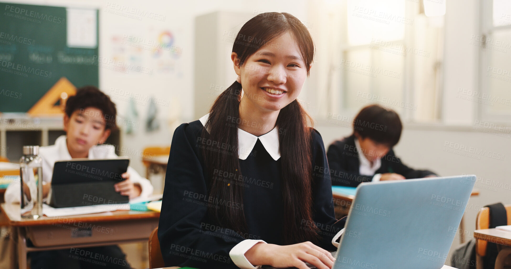 Buy stock photo Girl, child and laptop and portrait in classroom with smile, education and e learning on web with research for project. School, kid and computer for assessment, typing and happy at academy in Japan