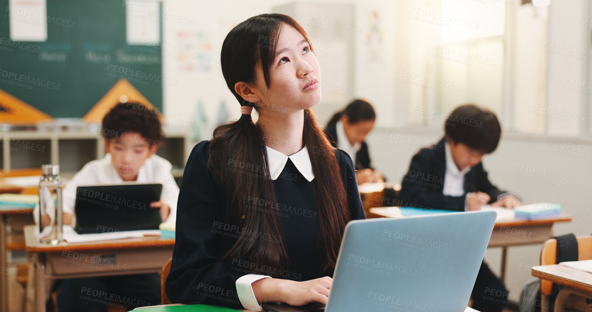 Buy stock photo Girl, child and laptop with thinking in classroom, education and e learning on web with research for project. School kids, learner and computer for assessment, test and solution at academy in Japan