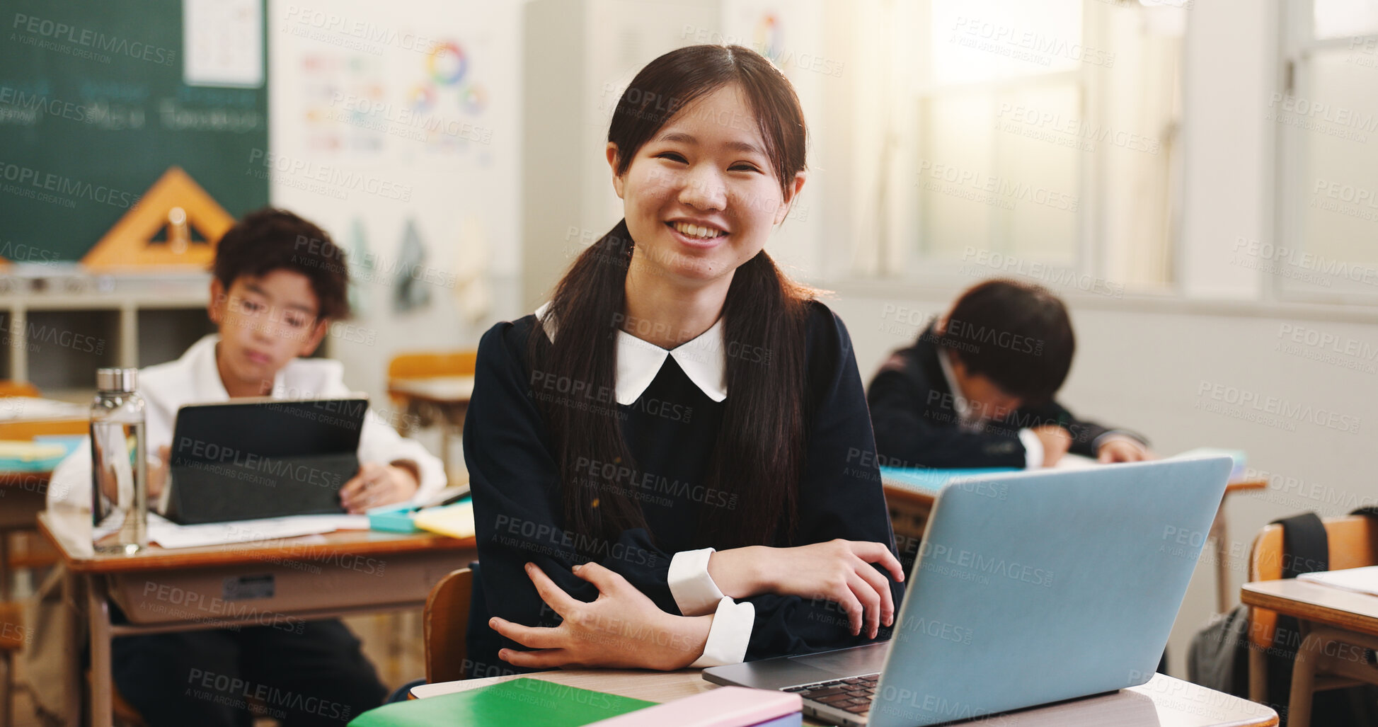 Buy stock photo Girl, kid and laptop and portrait in classroom with smile, education and e learning on web with research for project. School, child and computer for assessment, typing and happy at academy in Japan