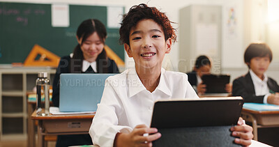 Buy stock photo Boy, child and smile in classroom with tablet, portrait and excited for e learning, development and progress. Learner, school kids and touchscreen for education, happy and study at academy in Japan