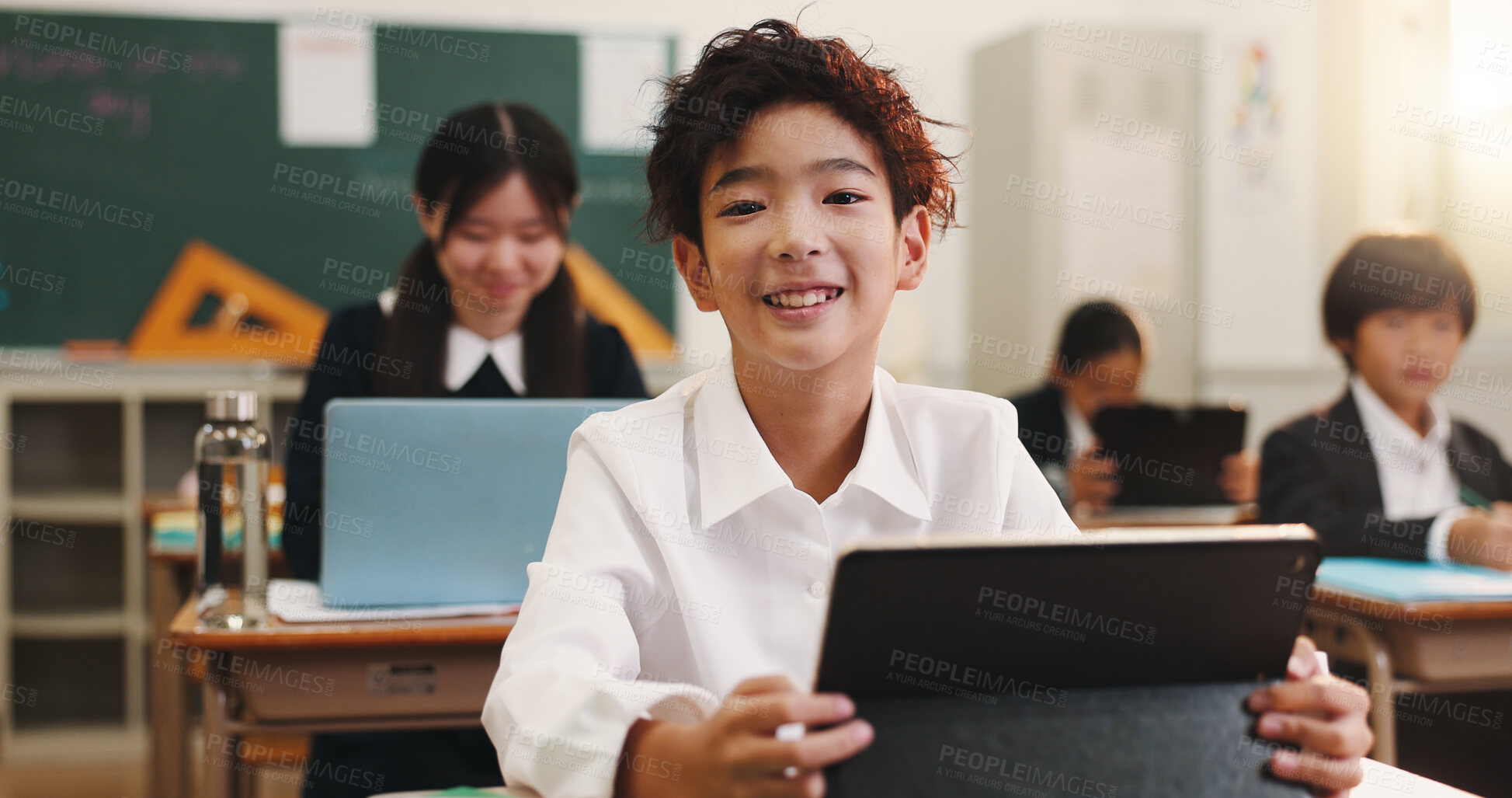 Buy stock photo Boy, child and smile in classroom with tablet, portrait and excited for e learning, development and progress. Learner, school kids and touchscreen for education, happy and study at academy in Japan