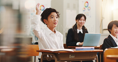 Buy stock photo Boy, raised hand and education in classroom for learning, question and study with problem solving test. School kids, learner and sign for answer, solution or progress with quiz at academy in Japan