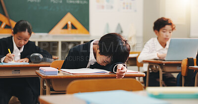 Buy stock photo Boy child, tired and sleeping in classroom with studying, education and burnout with books at academy. Kid, fatigue and exhausted with notes, dream and rest with scholarship at school in Japan