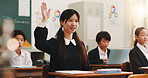 Girl, raised hand and question in classroom for idea, education and assessment with problem solving test. School kids, learner and sign for answer, solution or progress with quiz at academy in Japan