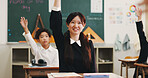 Girl, raised hand and question in classroom for learning, education and smile with problem solving test. School kids, learner and sign for answer, solution or progress with quiz at academy in Japan