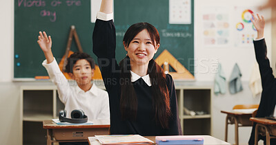 Buy stock photo Girl, raised hand and question in classroom for learning, education and smile with problem solving test. School kids, learner and sign for answer, solution or progress with quiz at academy in Japan