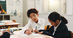 Boy, children and group for learning in classroom, writing and color pencil for creativity, study or development. School kids, education and progress with paper, notes or together at academy in Japan