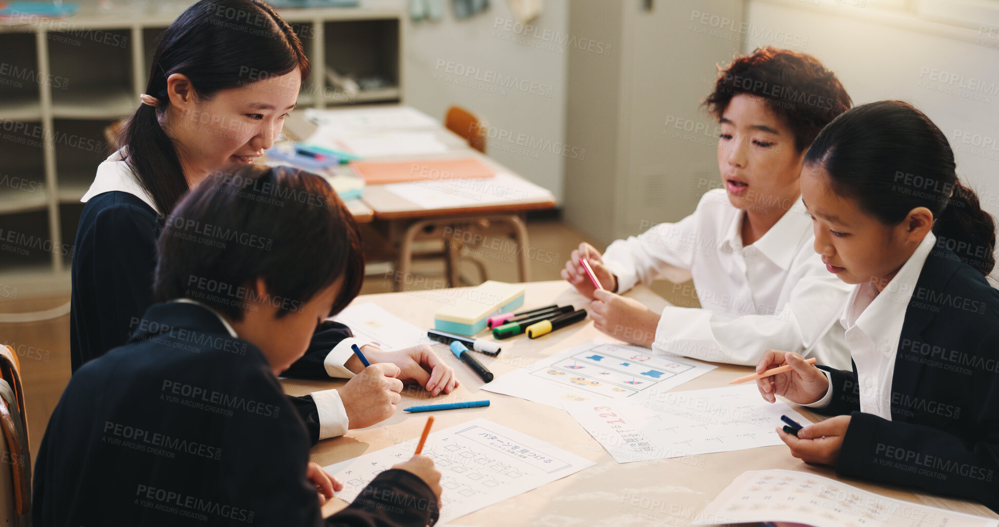 Buy stock photo Education, group and children in classroom, learning and help for assignment, textbook and reading. School, growth and development of kids, tutor and teamwork for project, knowledge and Japan