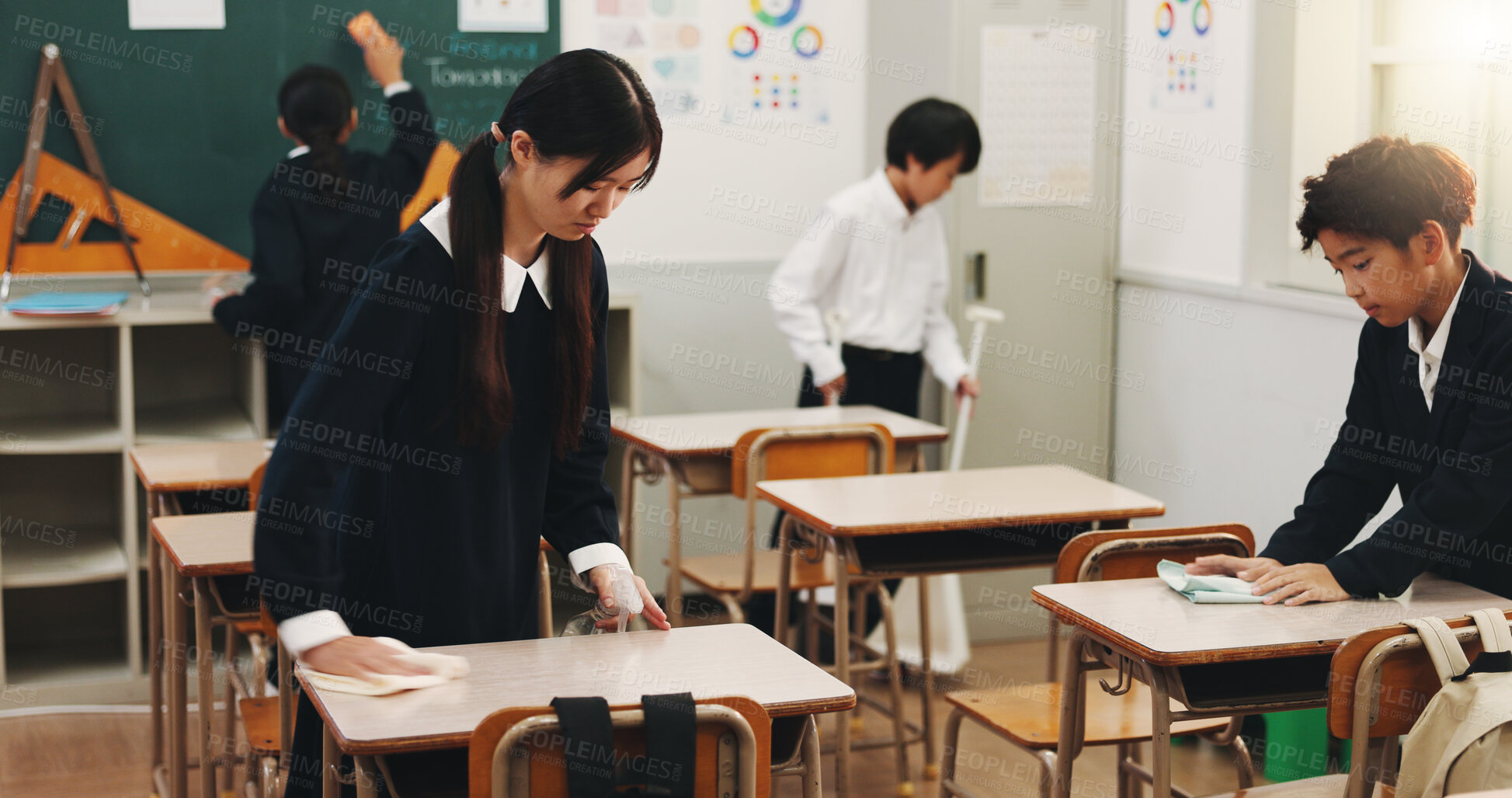 Buy stock photo Students, girl and cleaning desk at school for hygiene, learning responsibility and discipline in classroom. Japanese academy, people and wipe surface for disinfection, germs prevention and teamwork