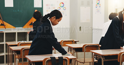 Buy stock photo Student, child and cleaning desk at school for hygiene, learning responsibility and discipline in classroom. Japanese academy, people and wipe surface for disinfection, germs prevention and values