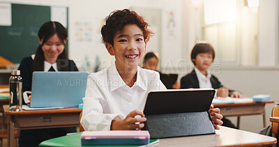 Buy stock photo Tablet, portrait and japanese child in classroom with learning, education and youth knowledge at school. Technology, smile and language academy with happy boy, growth and development with app