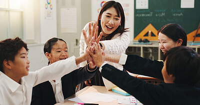 Buy stock photo Teacher, students and high five in classroom for language development, group project or collaboration. Japanese children, hands together and study with educator for support, knowledge or growth