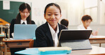 Boy, tablet and portrait in classroom with smile, education or info on web with research for project. School kids, learner and digital touchscreen for assessment, test and pride at academy in Japan