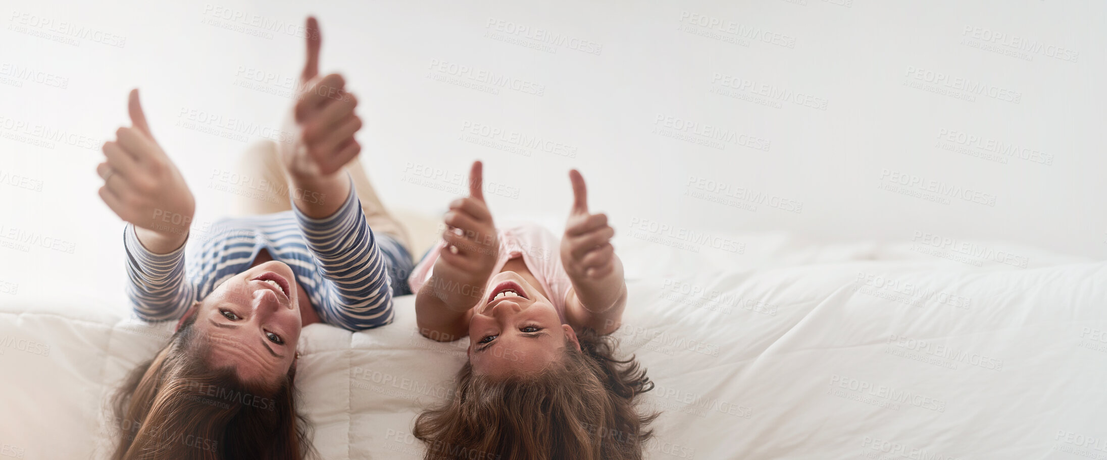 Buy stock photo Portrait, smile or thumbs up with woman and daughter upside down on bed in home for motivation or success. Like emoji, mockup space or yes with happy single parent woman and girl child in bedroom