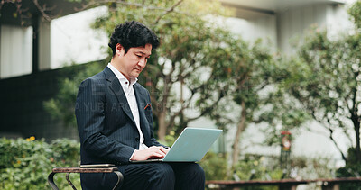 Buy stock photo Laptop, business man and typing at park for remote work, info or environmental consultant writing email on bench. Japanese worker, online or computer in city for sustainable project, review or update