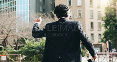 Buy stock photo Business, man and dance with headphones in city for listen to music, energy and podcast entertainment. Back,  person and freedom for streaming with morning commute, celebration and rhythm in Japan 