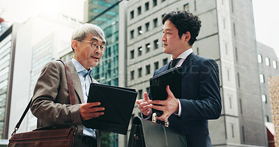 Buy stock photo Planning, teamwork and business people in city for documents, development or buildings. Developer, urban planner and mature professional Japanese colleagues speaking of project together in Tokyo