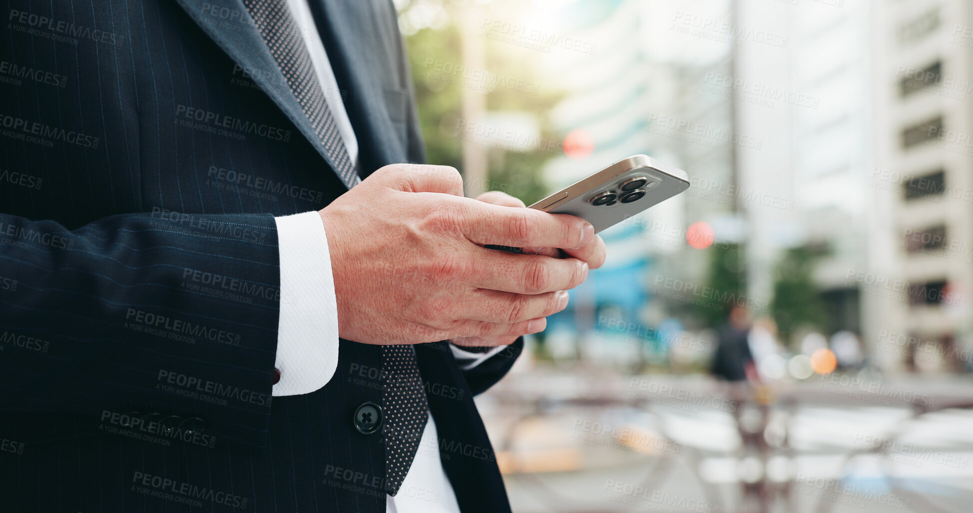 Buy stock photo Phone, hands and businessman in city with typing for email, communication or networking online in morning. Technology, cellphone and closeup of Japanese male lawyer with contact in urban town.