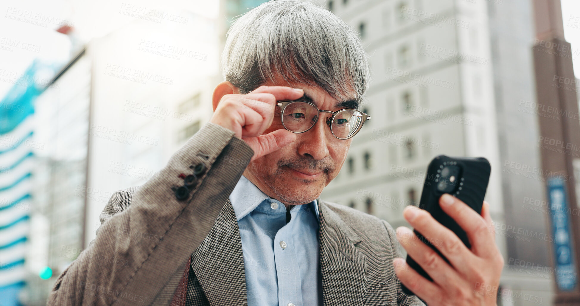 Buy stock photo Serious, travel and businessman with smartphone, city and research for real estate, listing and outdoor.  Glasses, reading and competition analysis with mobile, morning and mature person in Japan