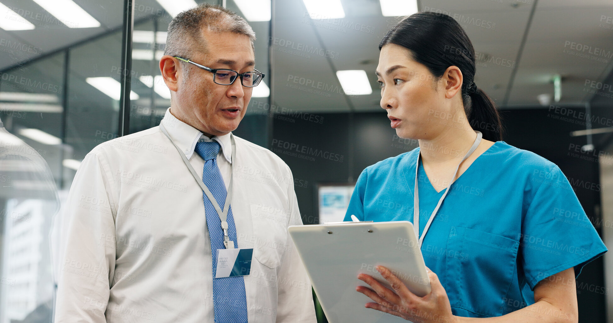 Buy stock photo Doctor, nurse and clipboard for healthcare, teamwork and medical feedback with discussion in hospital. Mature man, woman and planning for health report, collaboration or research with advice in Japan