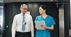 Doctor, nurse and clipboard for healthcare, feedback and medical collaboration with discussion in hospital. Mature man, woman and planning for health report, teamwork or research with advice in Japan