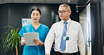 Doctor, nurse and clipboard for healthcare, planning and medical feedback with collaboration in hospital. Mature man, woman and discussion for health report, teamwork or research with advice in Japan