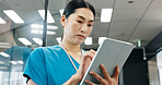 Nurse, tablet and planning of Japanese woman with thinking, web document and medical checklist in hospital. Surgeon, nursing and online research for health, wellness and clinic care with professional