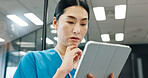 Nurse, tablet and thinking of Japanese woman with planning, web document and medical checklist in hospital. Surgeon, nursing and online research for health, wellness and clinic care with professional