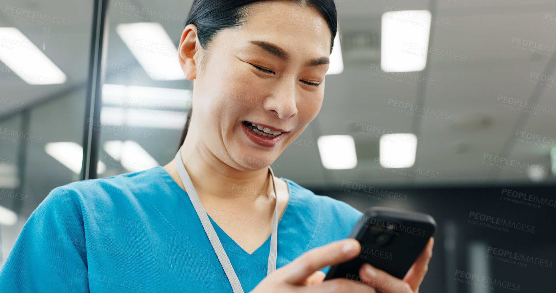 Buy stock photo Happy woman, nurse or phone in hospital for news, schedule update or connectivity. Japanese surgeon, smile or mobile in clinic for positive feedback, patient recovery or healthcare email with results