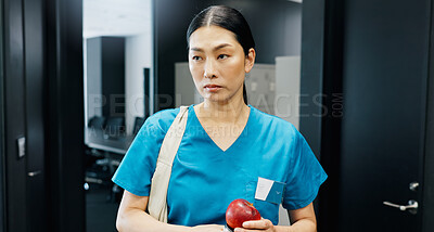 Buy stock photo Thinking, nurse and Asian woman with apple in office for nutrition, healthcare or healthy food choice. Morning, breakfast ideas or surgeon in wellness clinic with fruit, fibre and vitamin c in Japan