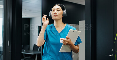 Buy stock photo Healthcare, woman and doctor in hospital with headphones, music and playlist for positive energy. Japanese nurse, clipboard and tech in clinic for research podcast, medical stories and streaming