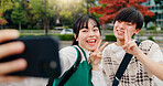 Happy couple, selfie and peace sign in park for social media, relationship and update status in Osaka. Japanese people, influencers and happy in city for photography, content creation or live stream