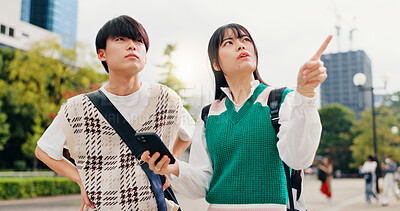 Buy stock photo Travel, pointing and couple in city with phone, outdoor morning adventure and online search for location. Smartphone, Japanese man and woman on urban sightseeing trip with mobile app for digital map