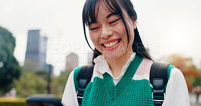 Buy stock photo Smile, phone and text of Japanese woman in city with social media, happy and web scroll outdoor. University, campus and college student with morning commute, travel and mobile networking in park