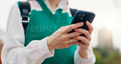 Buy stock photo Phone, hands and woman in city typing for communication, networking or contact on mobile app. Closeup, cellphone and student with email for university test results online outdoor in town in Japan.