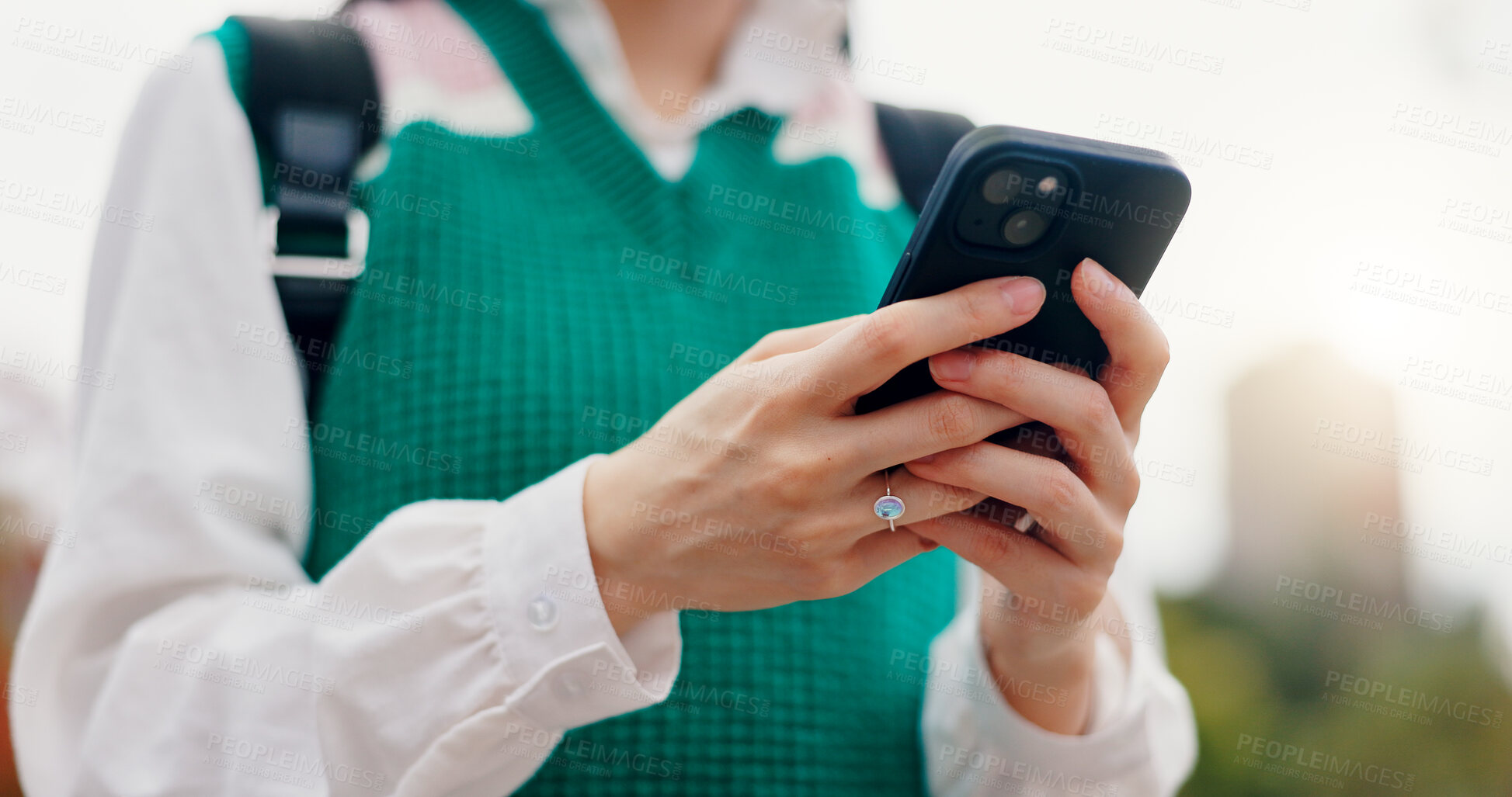 Buy stock photo Phone, hands and woman in city typing for communication, networking or contact on mobile app. Closeup, cellphone and student with email for university test results online outdoor in town in Japan.
