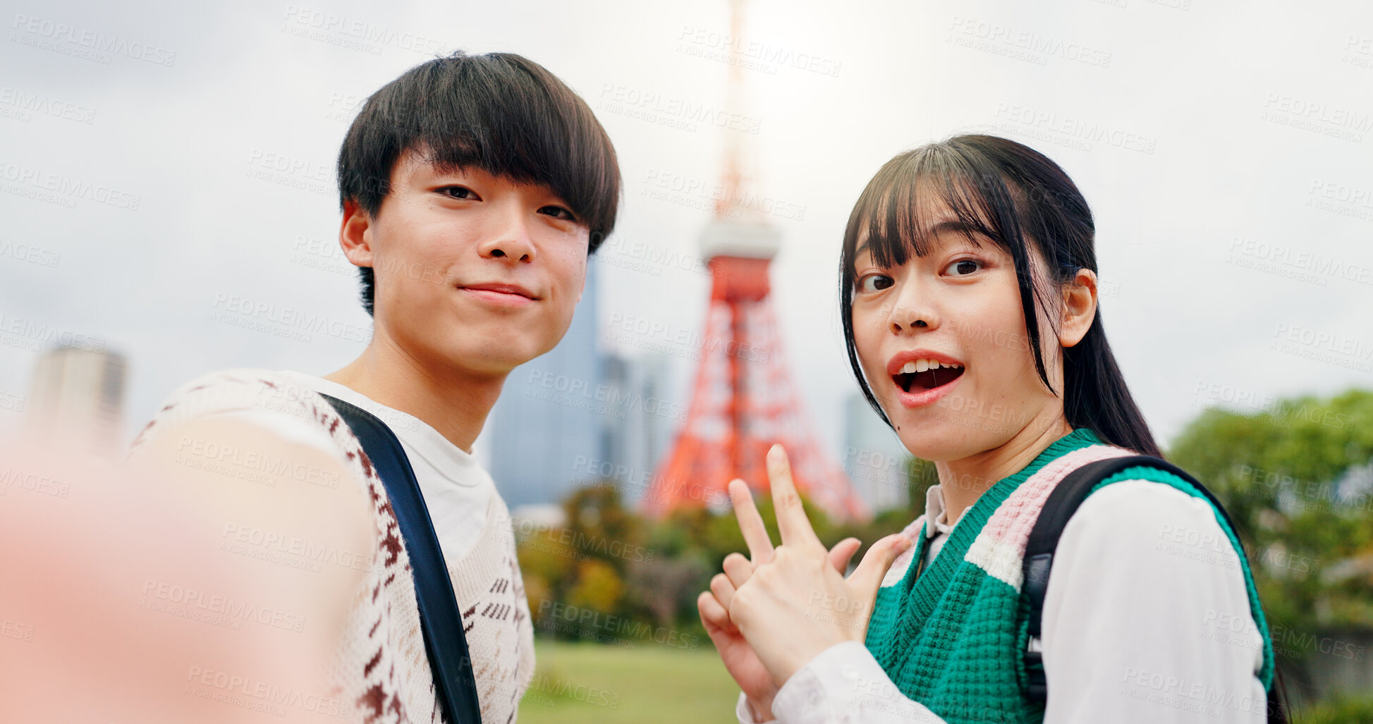 Buy stock photo Couple, portrait and outdoor with selfie for social media, travel journal and excited at Tokyo tower. Japanese man, woman and happy in city for photography, sightseeing and national landmark on date