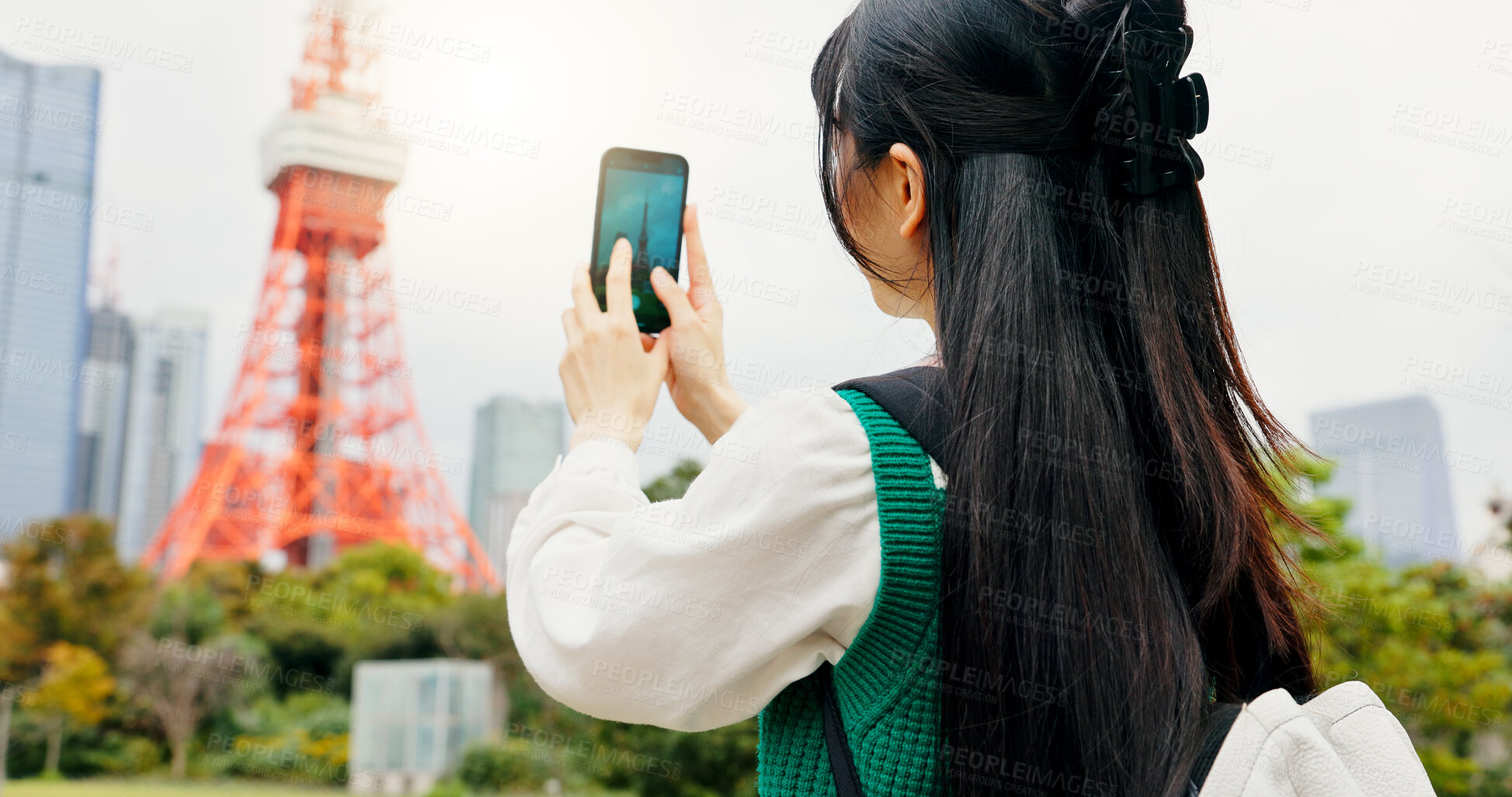 Buy stock photo Travel, photography and person with smartphone, city and capture of landmark, screen and content creation. Outdoor, influencer and tourist with mobile, display and picture of Tokyo Tower in Japan