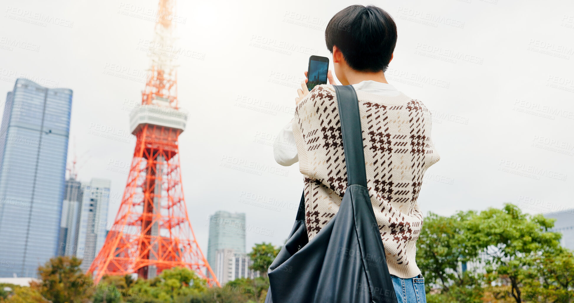 Buy stock photo Holiday, photography and person with smartphone, city and capture of landmark, screen and content creation. Outdoor, influencer and tourist with mobile, display and picture of Tokyo Tower in Japan