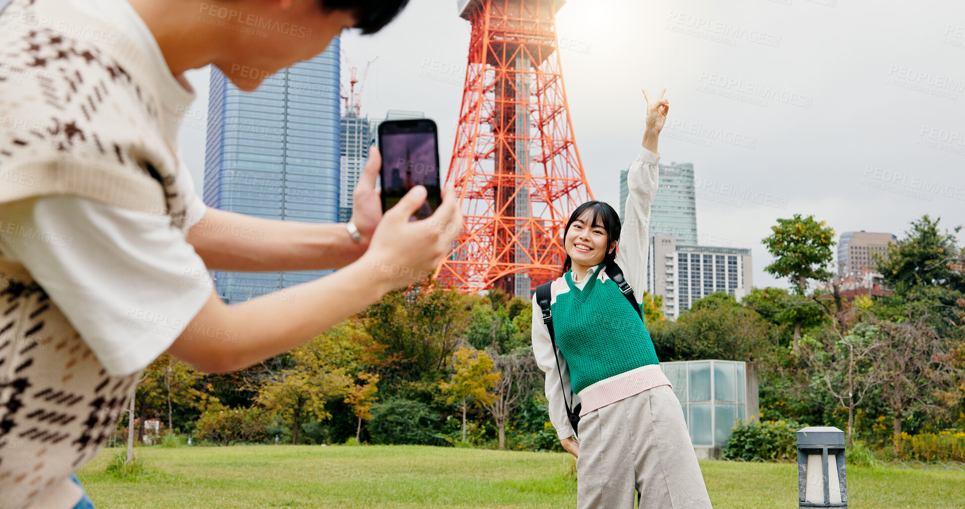 Buy stock photo Vacation, photography and couple with phone, city and capturing of moment, tourism or content creation. Outdoor, influencer and bonding of people, photographer or picture of Tokyo Tower in Japan