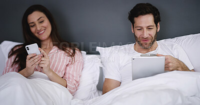 Buy stock photo Phone, tablet and couple resting in bed in home for networking, connectivity or browsing online. Happy, relax and young people with cellphone and digital technology in bedroom for contact in house.