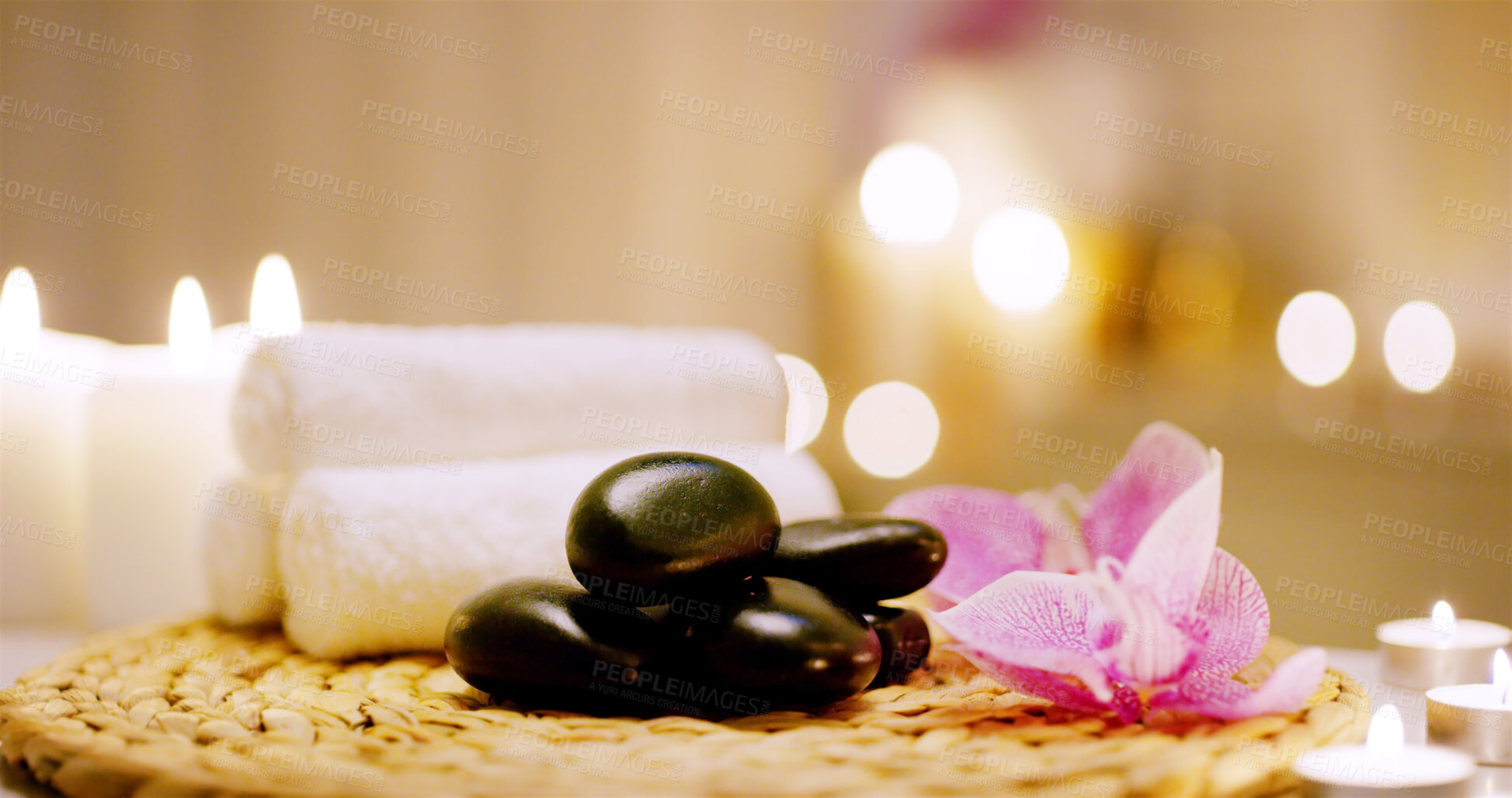 Buy stock photo Spa, stone and candles with towels for massage as objects in desk for relaxation, luxury or stress relief for peace. Wellness center, resort and health salon for aromatherapy with zen or mindfulness 