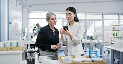 Buy stock photo Business women, coffee break and mobile phone with news, email and conversation as employee. Female people, technology and gossip for lunch, hot beverage and social media in accounting firm or office